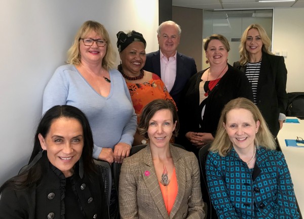 Group of men and women stand together, L-R top row: Theresa Gattung, Bernadette Pereira, David McLean, Angela McLeod, Alison Mau. L-R bottom row: Traci Houpapa, Erin Polaczuk, Katherine Rich.