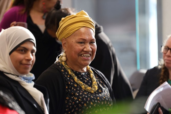 Pacific woman smiles at event