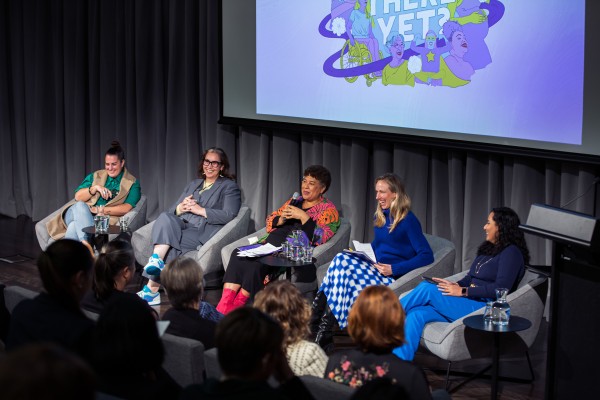 Five women in conversation on stage