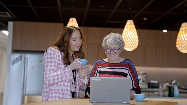 Two women looking at a laptop