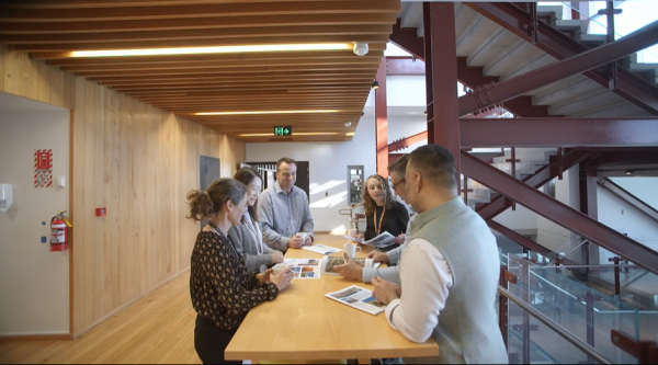 A group of people talking around a table