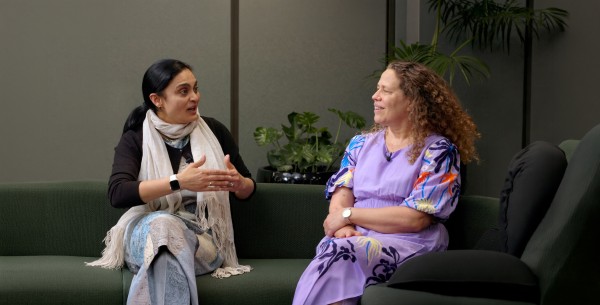 Two women talking on couch