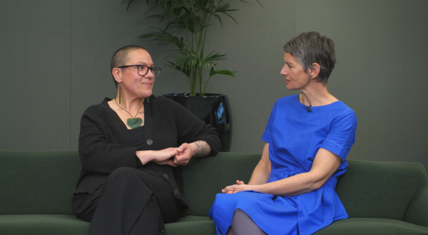 Two women on a couch discussing menopause 
